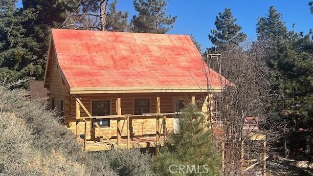 back of property featuring an outbuilding