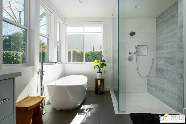 bathroom featuring tile patterned flooring, vanity, and independent shower and bath