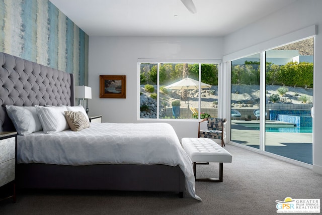 bedroom featuring multiple windows, carpet, and access to outside