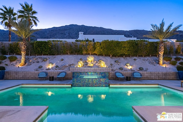 view of swimming pool featuring an in ground hot tub and a mountain view