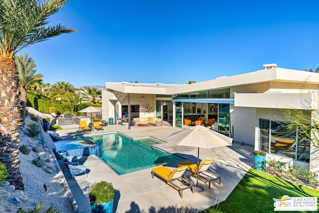 view of swimming pool with a patio area, outdoor lounge area, and ceiling fan