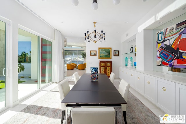 dining area with an inviting chandelier and built in shelves