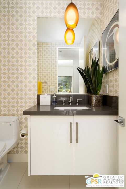 bathroom featuring vanity and toilet