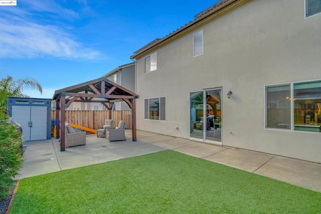 exterior space featuring a shed, a gazebo, a yard, an outdoor living space, and a patio area