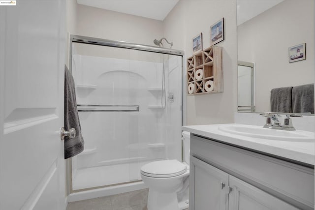 bathroom featuring walk in shower, tile patterned floors, vanity, and toilet