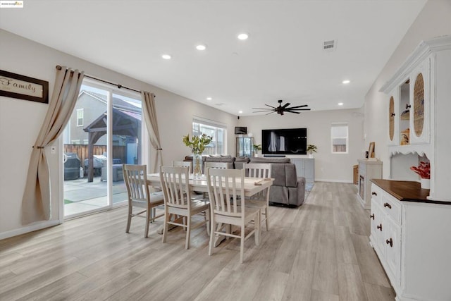 dining room with ceiling fan and light hardwood / wood-style floors