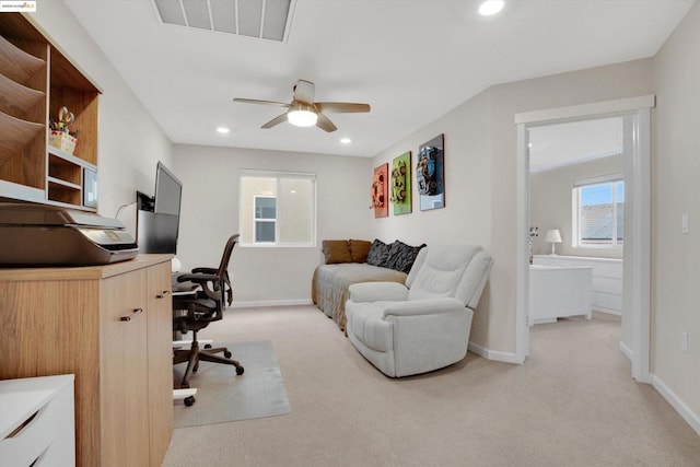 carpeted office space with ceiling fan