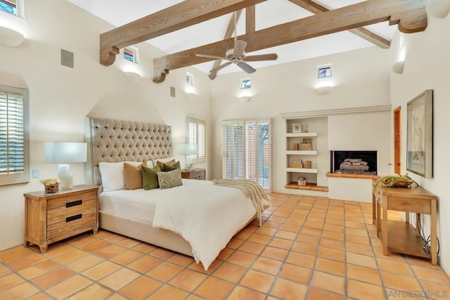 bedroom featuring ceiling fan, a towering ceiling, beam ceiling, and multiple windows