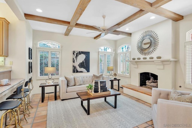 living room with light tile patterned floors, beam ceiling, and a healthy amount of sunlight