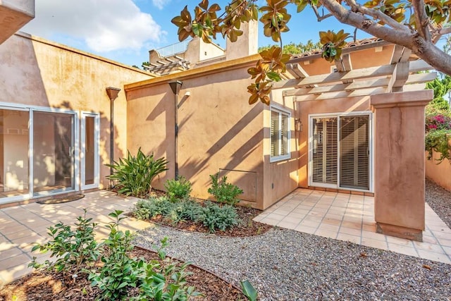 back of house featuring a pergola and a patio area