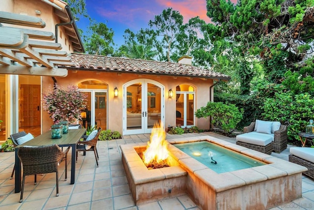 exterior space with french doors and an outdoor fire pit