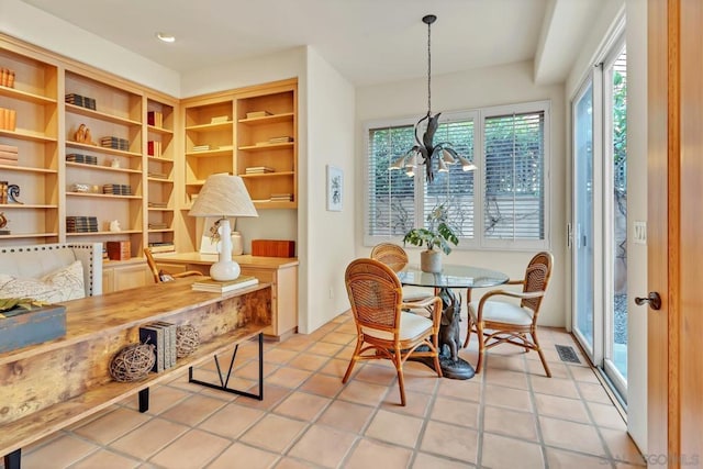 dining room featuring light tile patterned floors and a notable chandelier