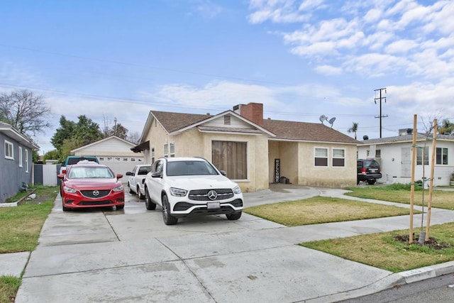 single story home with a garage and a front lawn