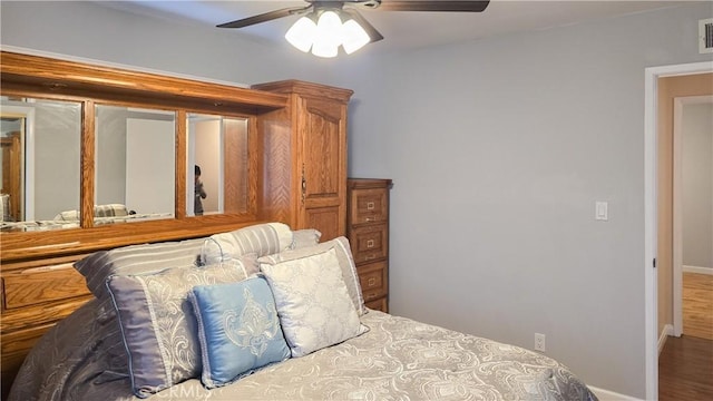 bedroom with ceiling fan and hardwood / wood-style floors