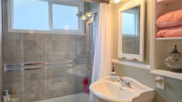 bathroom with sink and shower / tub combo