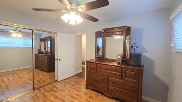 bedroom featuring light hardwood / wood-style floors, a closet, and ceiling fan