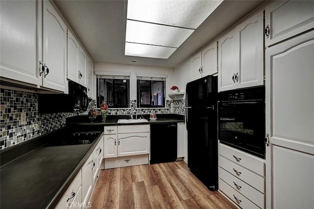 kitchen with backsplash, black appliances, light hardwood / wood-style floors, and white cabinets