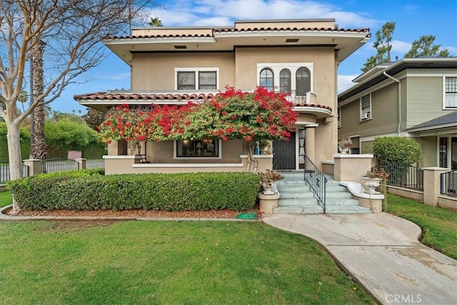 mediterranean / spanish-style house with a front yard