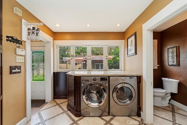 washroom with independent washer and dryer