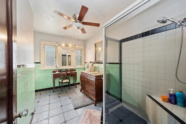 bathroom featuring tile walls, vanity, ceiling fan, walk in shower, and tile patterned floors