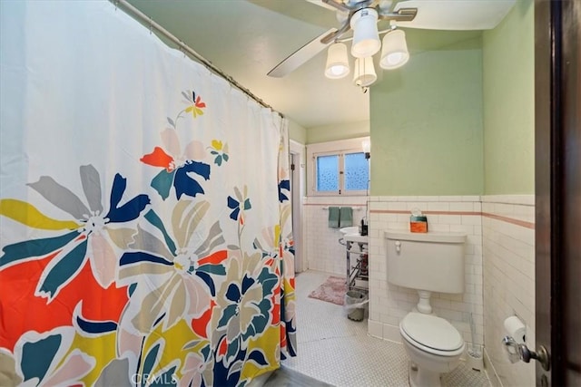 bathroom with tile walls, ceiling fan, tile patterned floors, and toilet