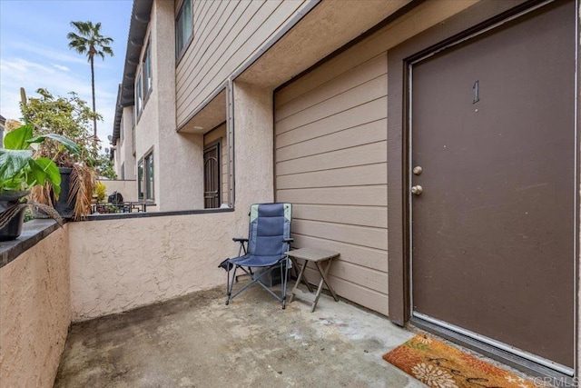 view of exterior entry featuring a patio