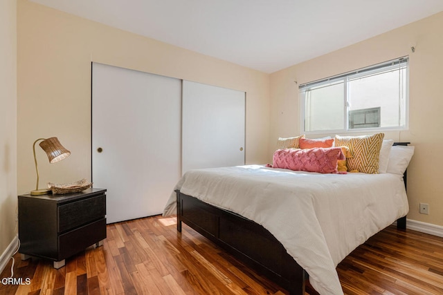 bedroom featuring hardwood / wood-style floors and a closet