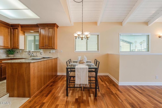 3233 Playa Ct, Oxnard, CA 93035 - dining area with wood finished floors, beam ceiling, and a chandelier