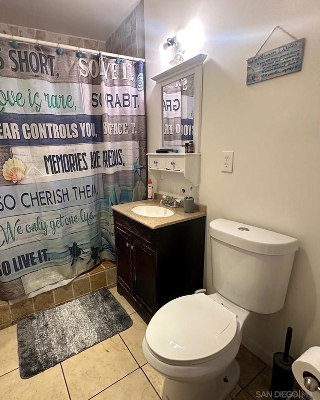 bathroom featuring tile patterned flooring, vanity, a shower with curtain, and toilet