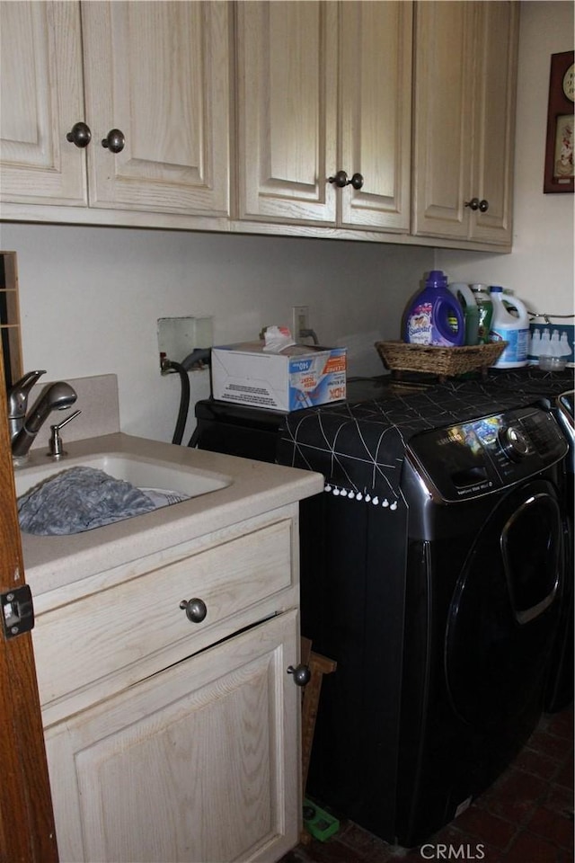 clothes washing area with cabinets, washer and clothes dryer, and sink