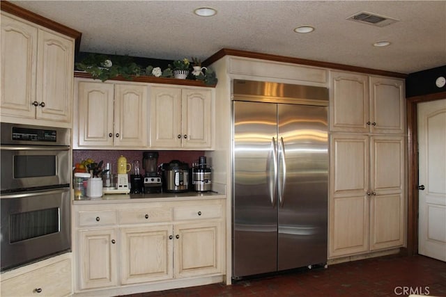 kitchen with stainless steel appliances and a textured ceiling