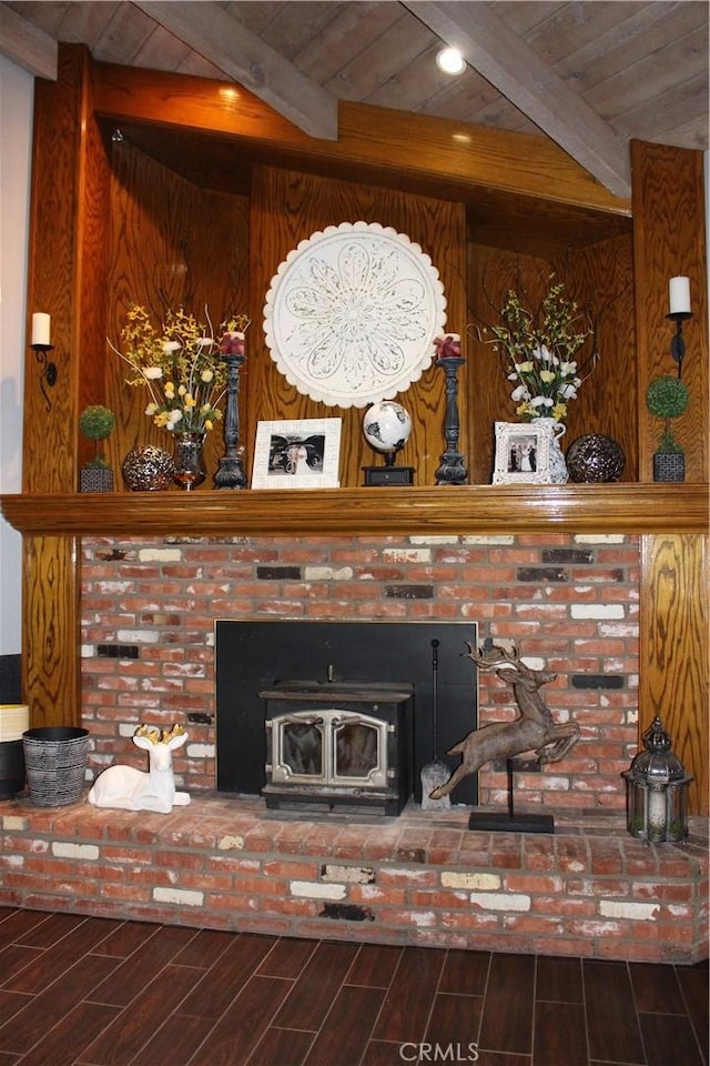 interior details featuring wood ceiling, beam ceiling, and a wood stove