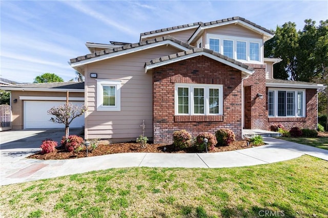 view of front of property featuring a garage, brick siding, concrete driveway, and a front yard