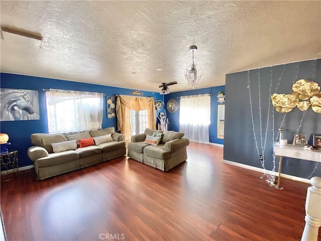 living room featuring dark hardwood / wood-style flooring and a textured ceiling