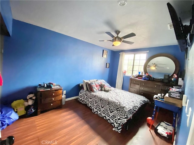 bedroom featuring hardwood / wood-style flooring and ceiling fan