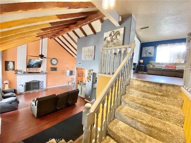 interior space featuring hardwood / wood-style flooring, ceiling fan, and lofted ceiling with beams