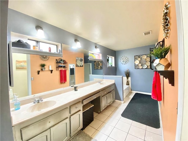 bathroom featuring vanity, a bath, and tile patterned flooring