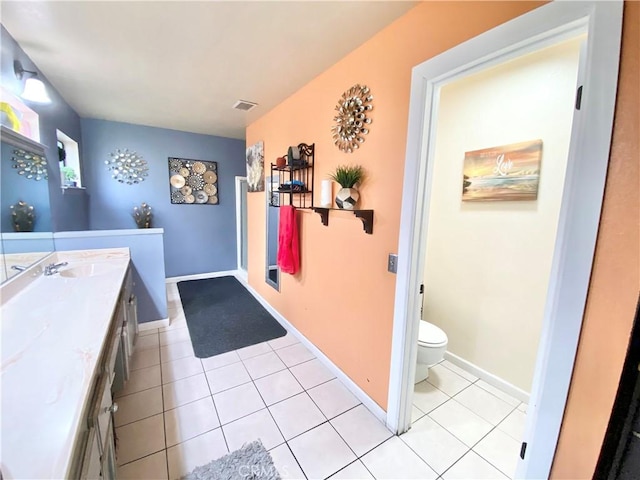 bathroom with visible vents, baseboards, toilet, tile patterned flooring, and vanity