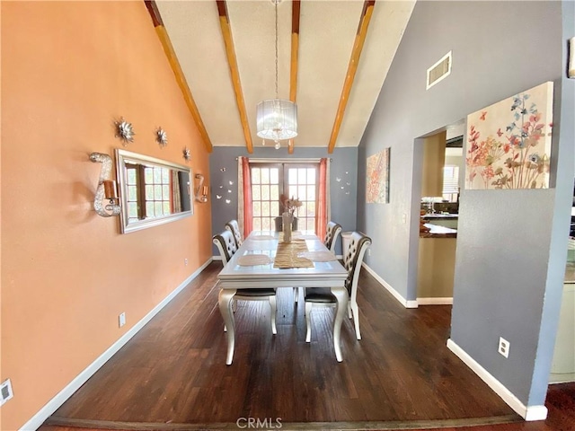 dining room with dark hardwood / wood-style floors, a chandelier, and high vaulted ceiling