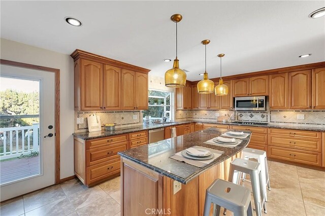 31750 1st St, Acton, CA 93510 - kitchen with a sink, a breakfast bar area, backsplash, appliances with stainless steel finishes, and a kitchen island