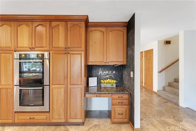 31750 1st St, Acton, CA 93510 - kitchen featuring double oven, built in study area, and dark stone countertops