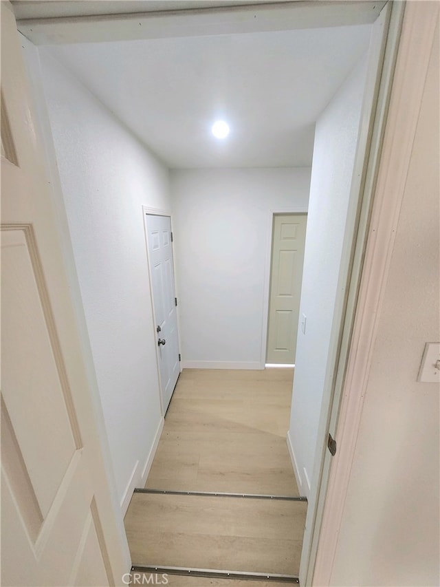 hallway with light wood-type flooring