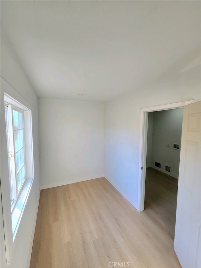 empty room with light hardwood / wood-style floors