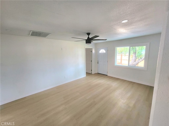 interior space featuring ceiling fan, light hardwood / wood-style flooring, and a textured ceiling