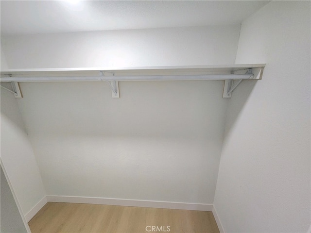 walk in closet featuring light hardwood / wood-style flooring