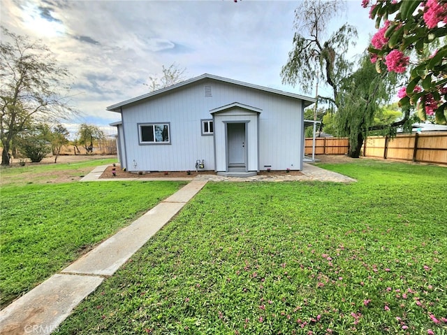 view of outbuilding with a lawn