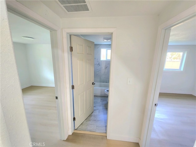 hall with light hardwood / wood-style floors