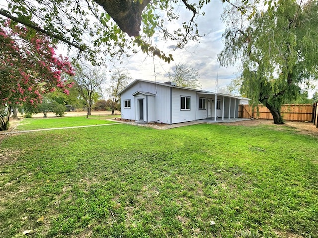 rear view of property with a yard and a patio