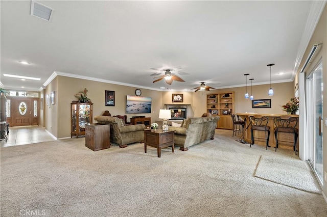 living room with ornamental molding, plenty of natural light, light carpet, and bar area