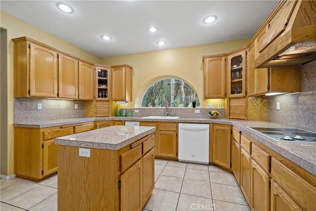 kitchen featuring premium range hood, a kitchen island, sink, light tile patterned floors, and white appliances